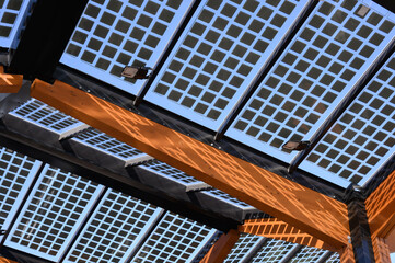 The photovoltaic roof of an electric charging station at a roadside car park. The supporting...