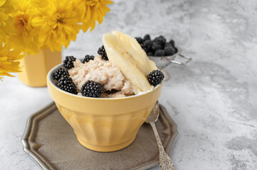 oatmeal for breakfast. Healthy breakfast of oatmeal, banana and blackberries and mulberries