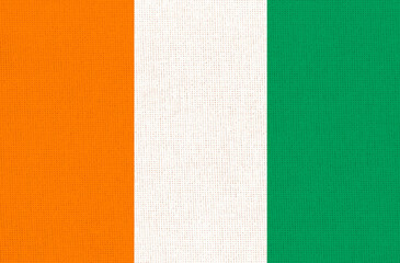 Cote d'Ivoire flag on fabric surface. Ivory Coast national flag on textile