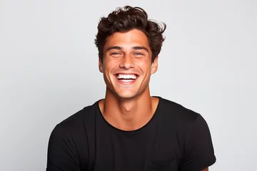 Tuinposter Smiling man with curly hair and black t-shirt, radiating joy and charisma. White Background © EricMiguel