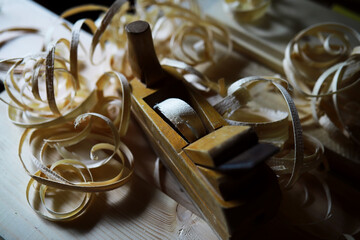 Plane jointer carpenter or joiner tool and wood shavings. Woodworking tools on wooden table....