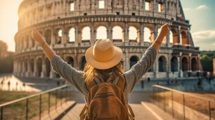 Fotobehang Female traveler with a backpack in front of the Colosseum in Rome, Italy © Aevan