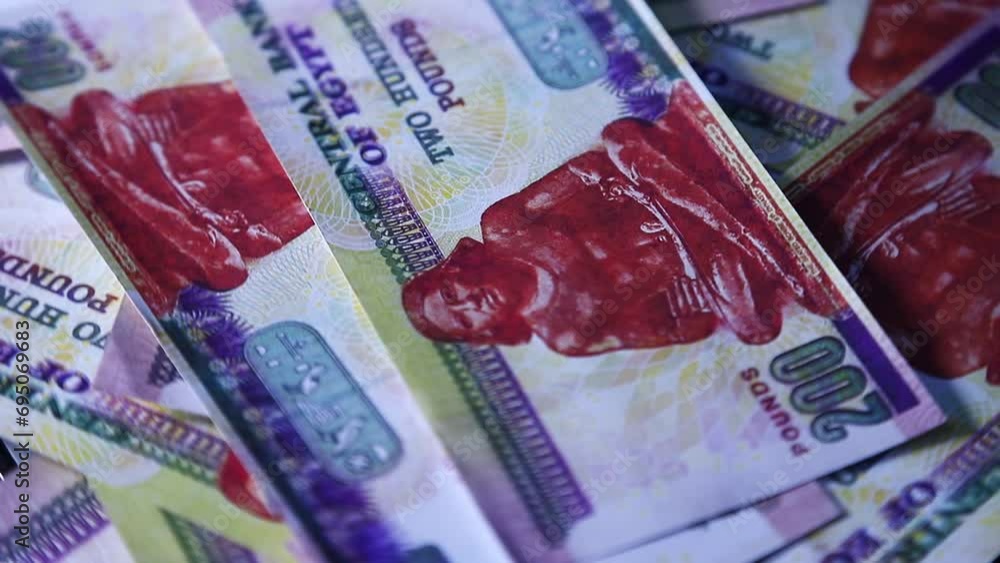 Poster camera panning 360 degrees around spread 200 egyptian pound notes. camera moving around scattered po