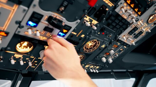 close-up hand of the pilot captain presses the buttons on the control panel to start the engine of the plane Flight simulator close-up