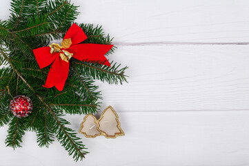 Fototapeta na wymiar Christmas tree decorations on fir tree branches. Christmas decor on a light background.