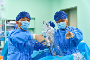 Asian surgeons work in a modern operating room