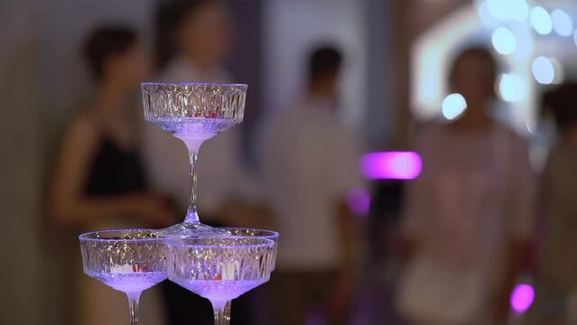 Tower of glasses at celebration party. Welcome drinks, tower of champagne or sparkling wine. Empty with red berry. Restaurant ready for reception. Alcoholic beverage.