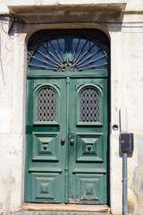 Fototapeta premium Old Door in Lisbon, Portugal. The Date 1880 in the Iron Grille at the Top of the Door.