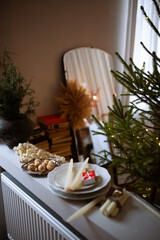 still life with a candle, nuts and popcorn decorations and mirror and books on background