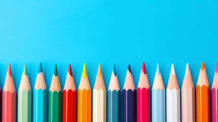 A row of colored pencils lined up on a blue background