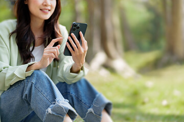 woman using smart phone at outdoor park.