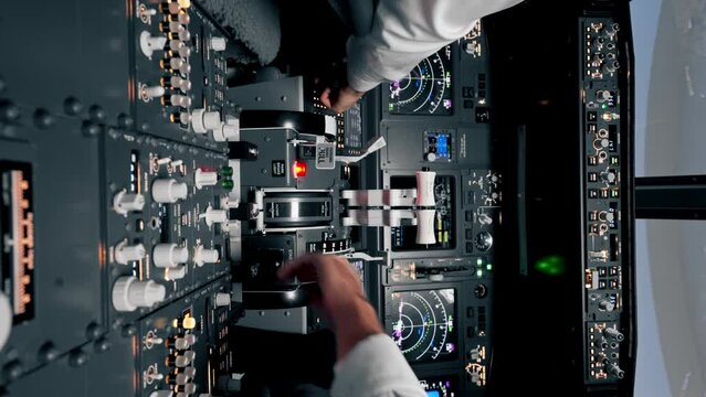 vertical video Airplane pilot controls throttle during flight or takeoff Cockpit view close-up of air traffic control