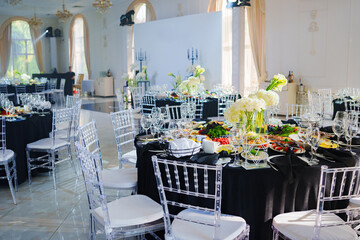 Beautifully set banquet table with black tablecloth. S