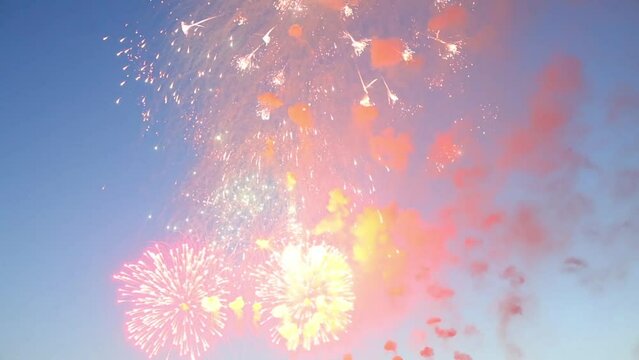 Many beautiful fireworks on blue sky at summer evening 