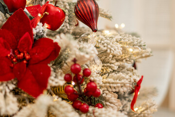 Close up Christmas Tree with Decorations , Lights and red flowers. 