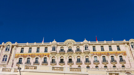 Stunning summer view of Monaco's iconic buildings next to the casino. Architectural elegance meets vibrant summer life, capturing the essence of luxury and charm in this Mediterranean gem.