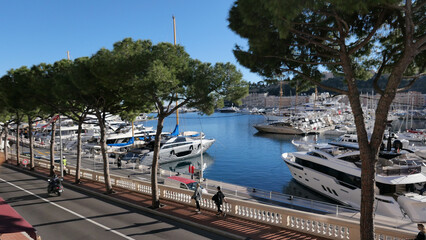 Monaco, France - December 17, 2023: The picturesque Port Hercule, Monaco, adorned with pristine white yachts at rest. A picturesque seaside that captures the luxury and elegance of Monaco's port.