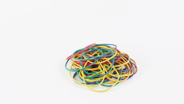 There is a heap of multi-colored rubber bands then disappears