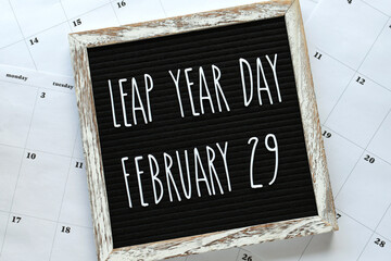 Leap Year Day, February 29, message board flat lay on calendar pages - concept for event that...