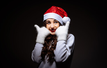 A Woman Wearing a Santa Hat and Gloves