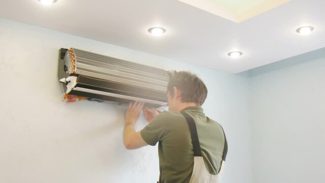Worker install air conditioning, camera rotate. Time lapse.