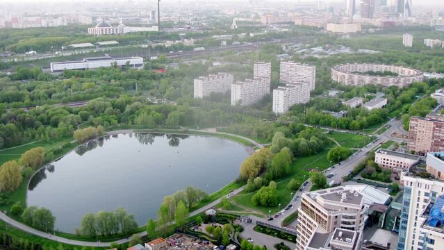Cityscape with houses around pond at summer day in Moscow