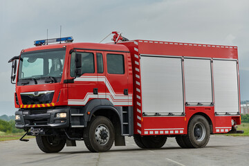 In this captivating scene, a state-of-the-art firetruck, equipped with advanced rescue technology, stands ready with its skilled firefighting team, prepared to intervene and respond rapidly to