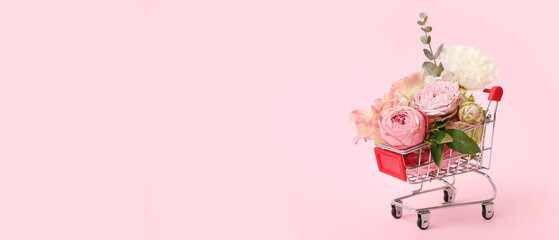 Small shopping cart with beautiful flowers on pink background with space for text - obrazy, fototapety, plakaty