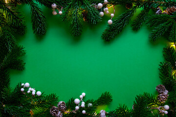 Winter green background with decoration, light, branch of Christmas tree.