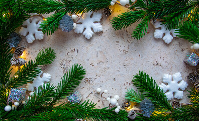 Christmas tree spruce, snowflake, cone, light on the wood background. Copy space. Top view.