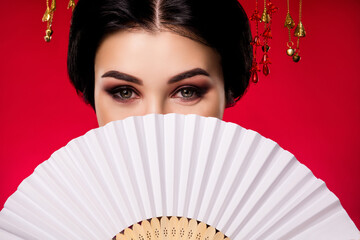 Photo of sophisticated elegant lady hiding face japanese fan traditional isolated on red gradient...