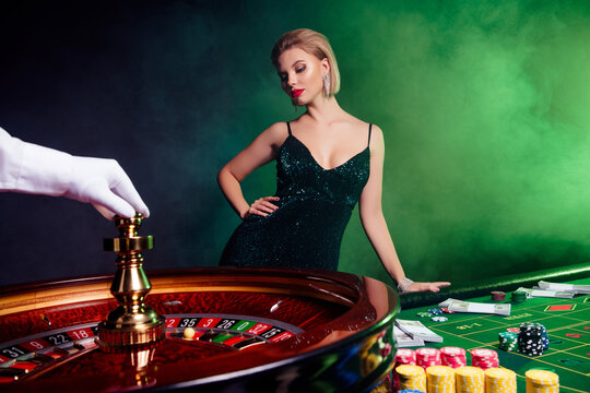 Photo of gorgeous lady have fun weekend in las vegas casino club bet follars million wait for ball in spinning wheel