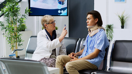 Senior doctor examining asian patient, checking eye vision during checkup visit consultation in...