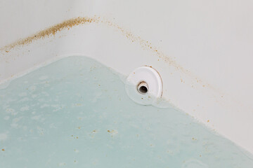 Whirlpool tub or jetted bathtub with dirty water. Household chores, bathroom cleaning and...