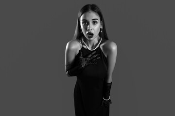 Scared young woman on dark background