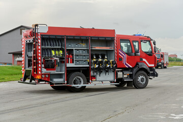 Fototapeta na wymiar In this captivating scene, a state-of-the-art firetruck, equipped with advanced rescue technology, stands ready with its skilled firefighting team, prepared to intervene and respond rapidly to