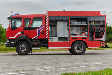 Fototapeta na wymiar In this captivating scene, a state-of-the-art firetruck, equipped with advanced rescue technology, stands ready with its skilled firefighting team, prepared to intervene and respond rapidly to
