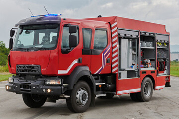 In this captivating scene, a state-of-the-art firetruck, equipped with advanced rescue technology, stands ready with its skilled firefighting team, prepared to intervene and respond rapidly to