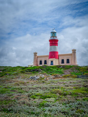 Fototapeta na wymiar Vertical shot of the Cape Agulhas Lighthouse, southernmost tip of Africa during a cloudy day, L'Agulhas, South Africa