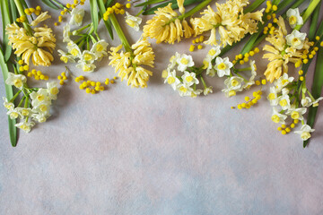Yellow flowers hyacinths, daffodils and mimosa on a decorative background. Spring holiday card, copy space