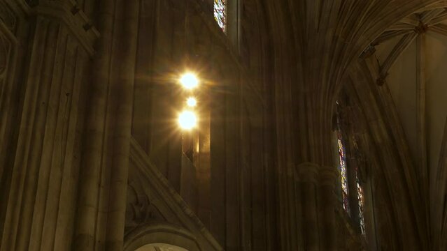 LOW ANGLE VIEW: Sunbeams shine into beautiful interior of Canterbury Cathedral. Magnificent architectural details in every corner of the famous religious and historical monument, protected by UNESCO.