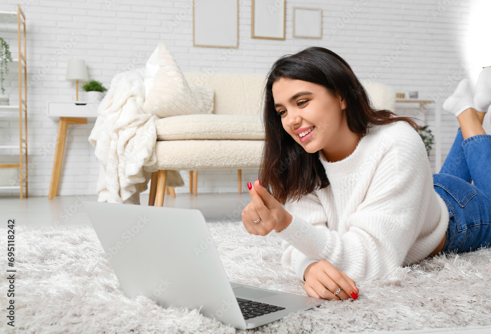 Canvas Prints Young woman with laptop video chatting on online date at home