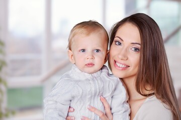 Happy loving woman mother holding baby