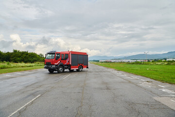 In this captivating scene, a state-of-the-art firetruck, equipped with advanced rescue technology, stands ready with its skilled firefighting team, prepared to intervene and respond rapidly to