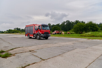 Fototapeta na wymiar In this captivating scene, a state-of-the-art firetruck, equipped with advanced rescue technology, stands ready with its skilled firefighting team, prepared to intervene and respond rapidly to