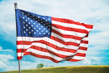 American flag wave over a green field.