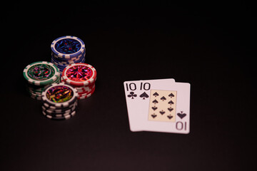 The interior of the casino. Playing cards close-up at the poker table combination of cards a pair of tens.