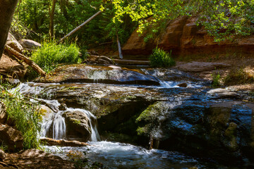 Water cascades over layers of mossy rock along the Tonto Creek in the Mogollon Rim country of...