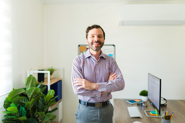 Professional happy man at the office working as a supervisor boss