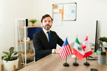 Latin diplomat working on the TMEC at his office